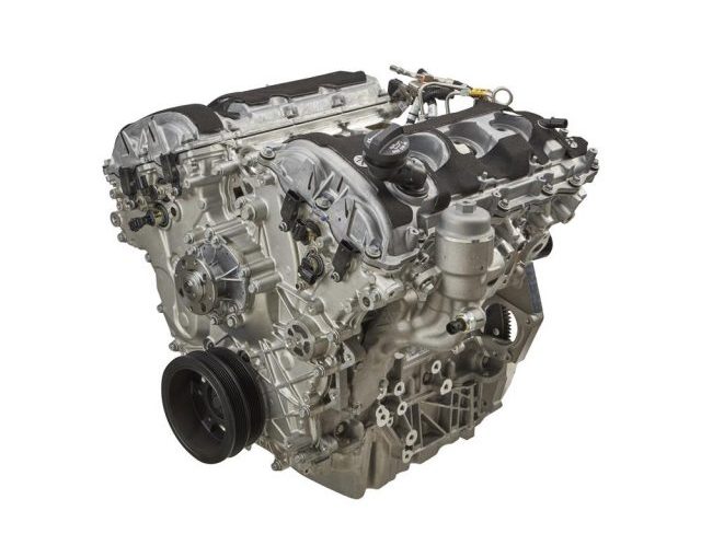 Detailed view of a silver automotive engine with various components and connections.